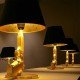 Gun bedside table lamp design Flos gold or black color side view